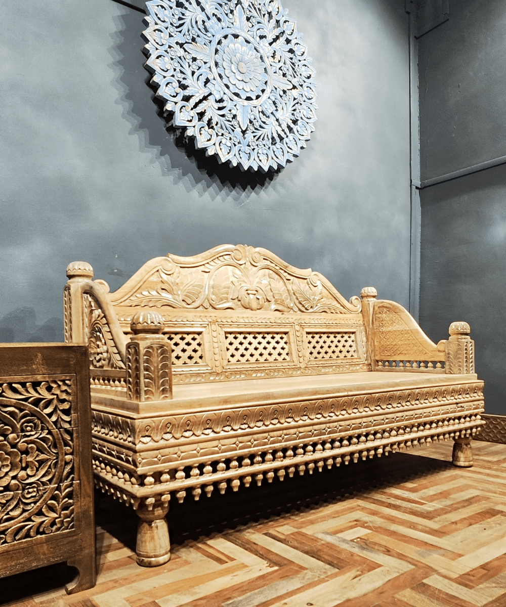 Side profile showing detailed hand carvings on the frame