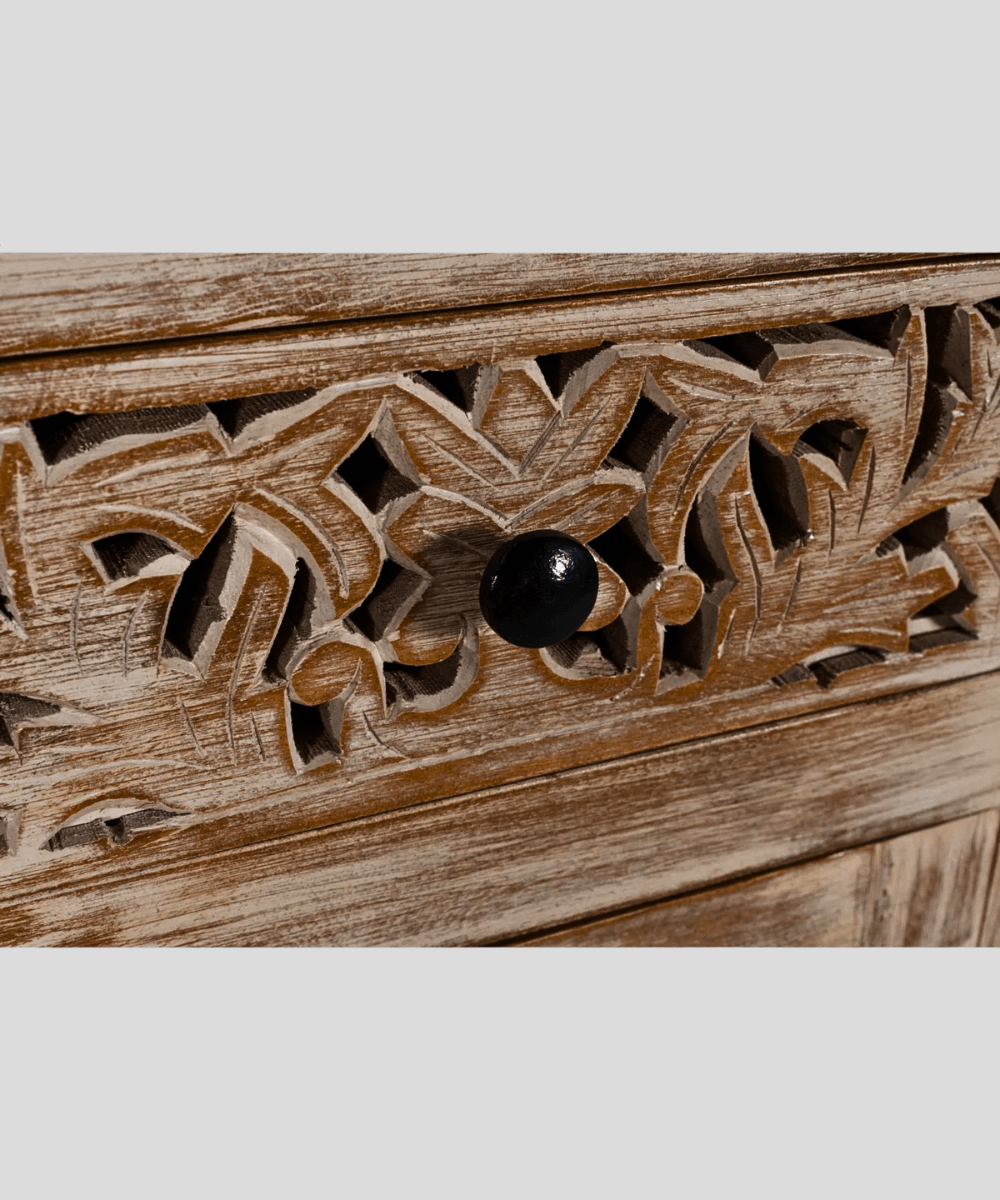 Close-up of intricate floral lattice carvings on cabinet doors
