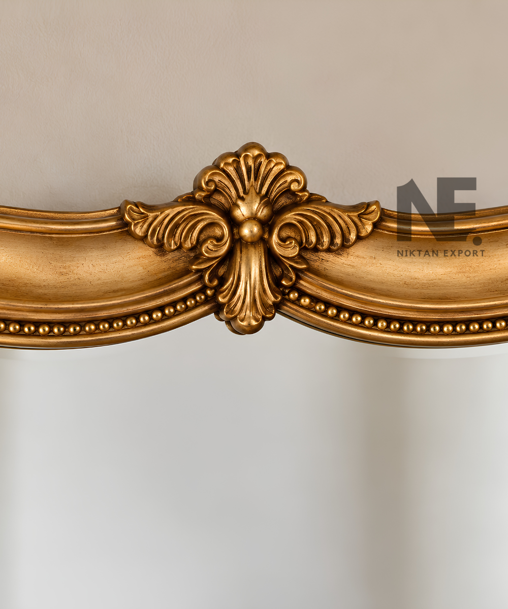 Tall gold-framed mirror against a neutral wall