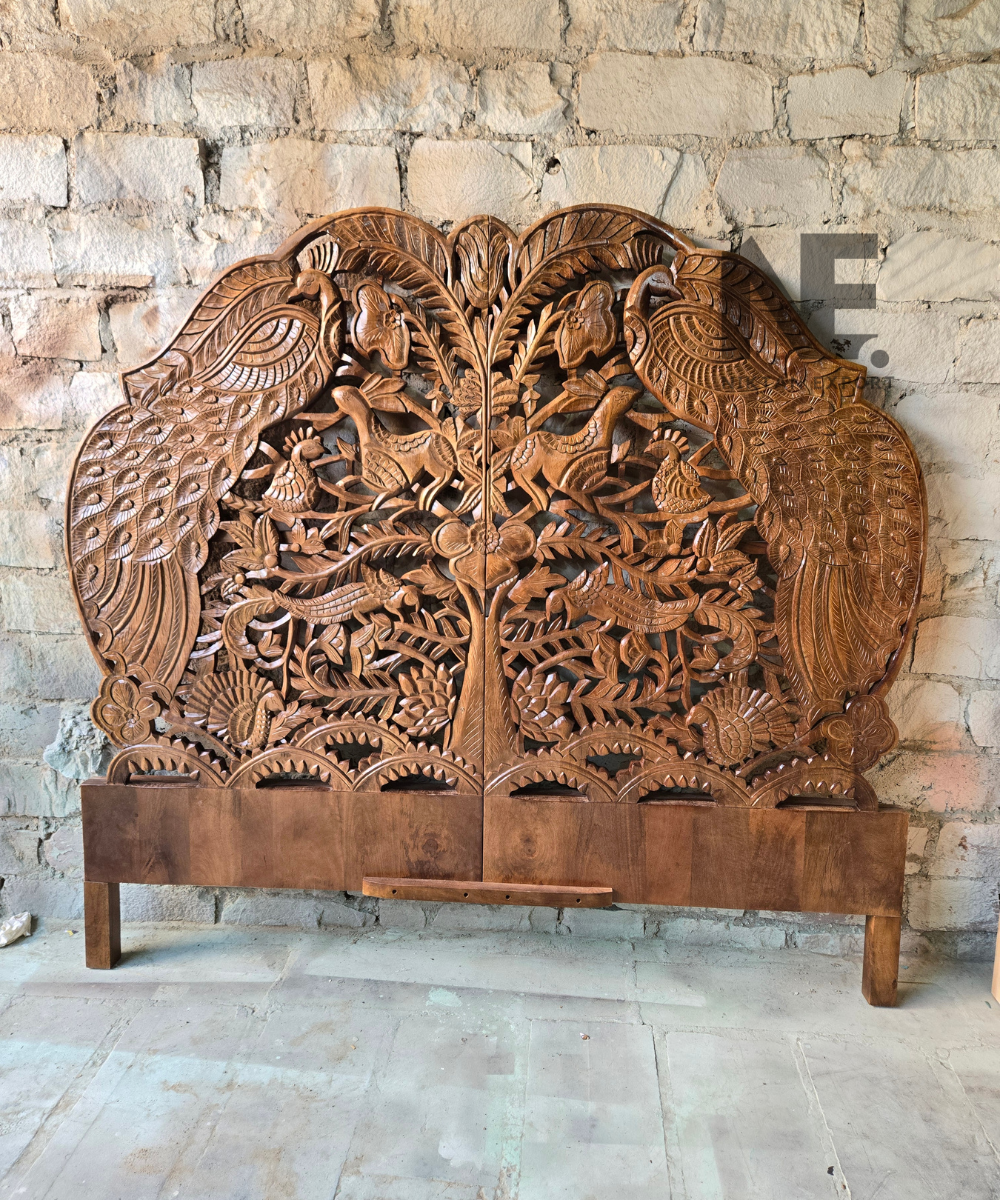 Wooden headboard with intricate peacock carving