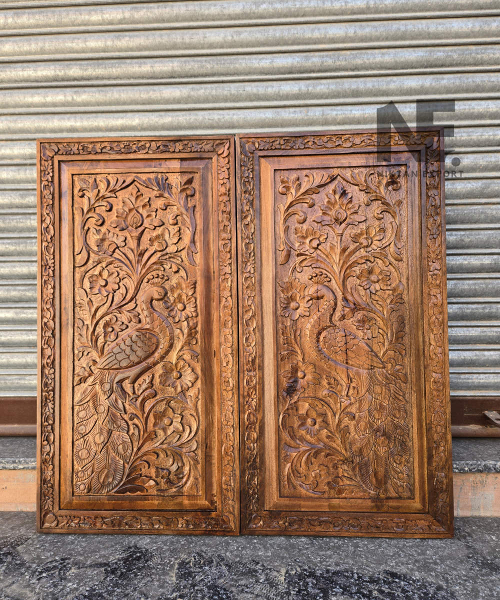 Pair of carved wood panels with symmetrical peacock designs