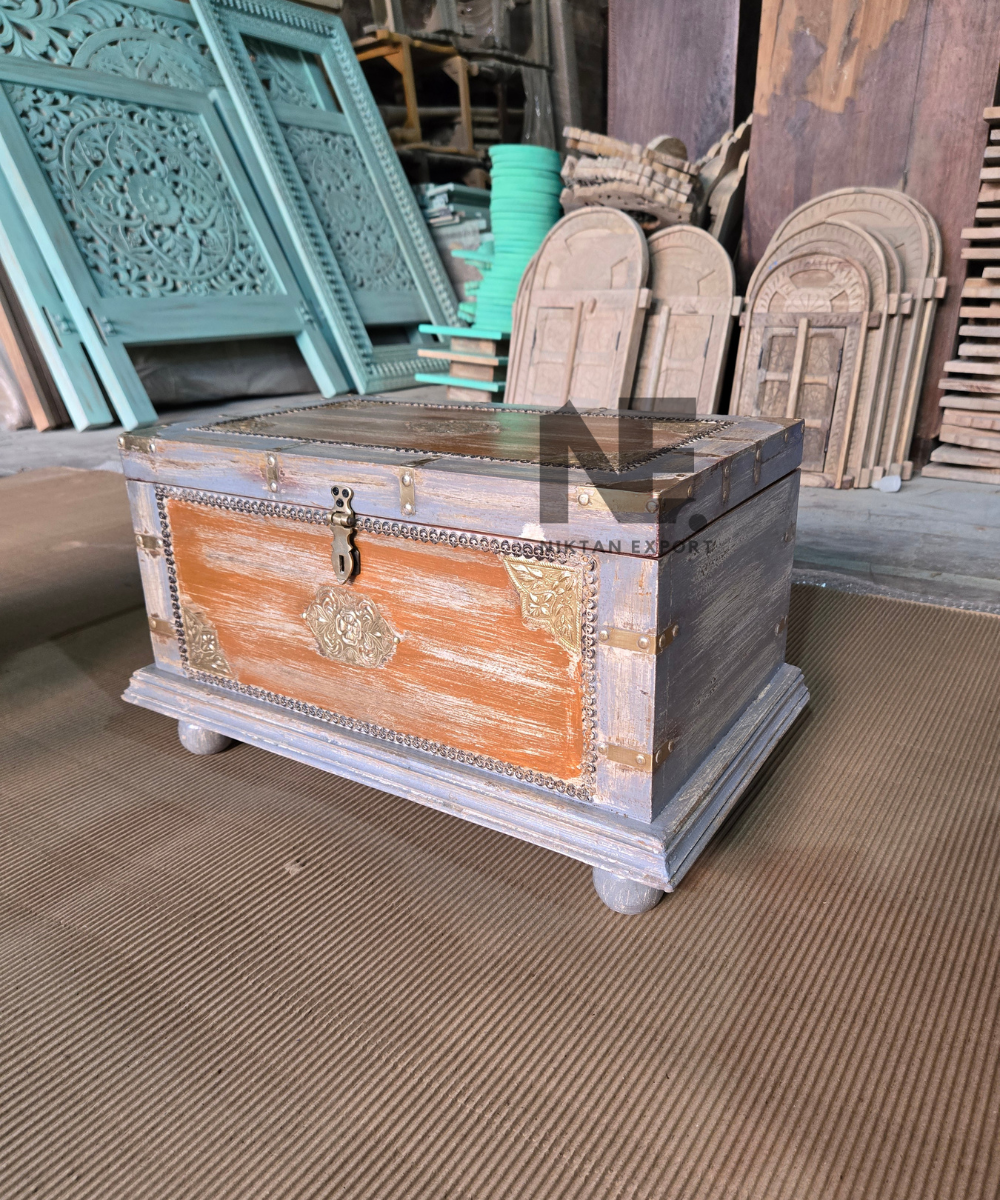 Rustic wooden trunk with decorative brass-tone accents