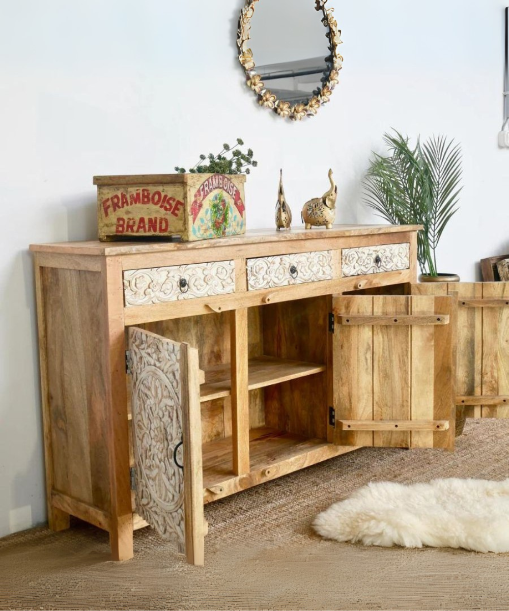 Close-up of intricate floral carvings on the white wooden cabinet doors