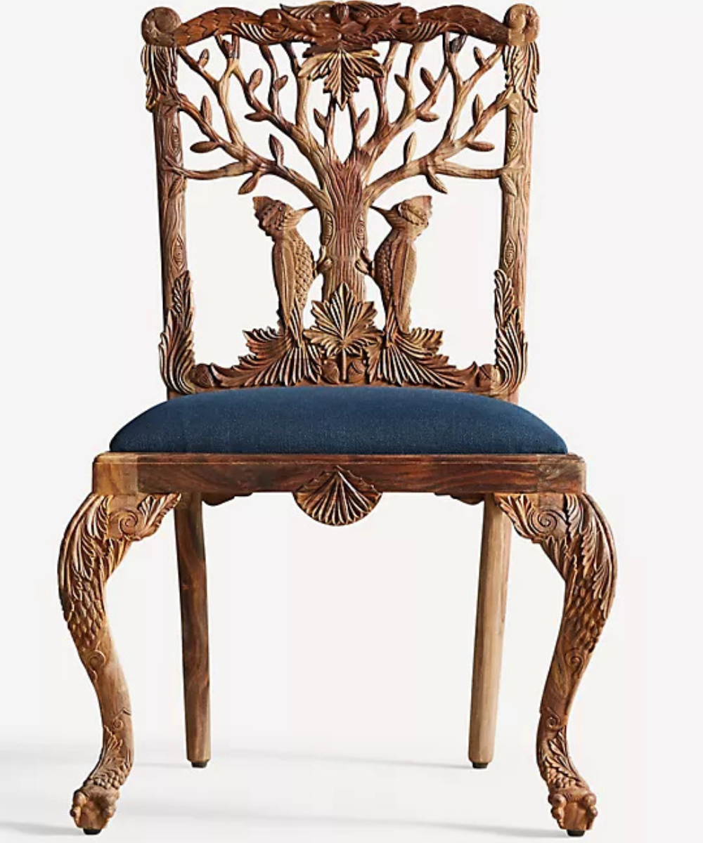 Front view of carved wooden chair with navy-blue seat