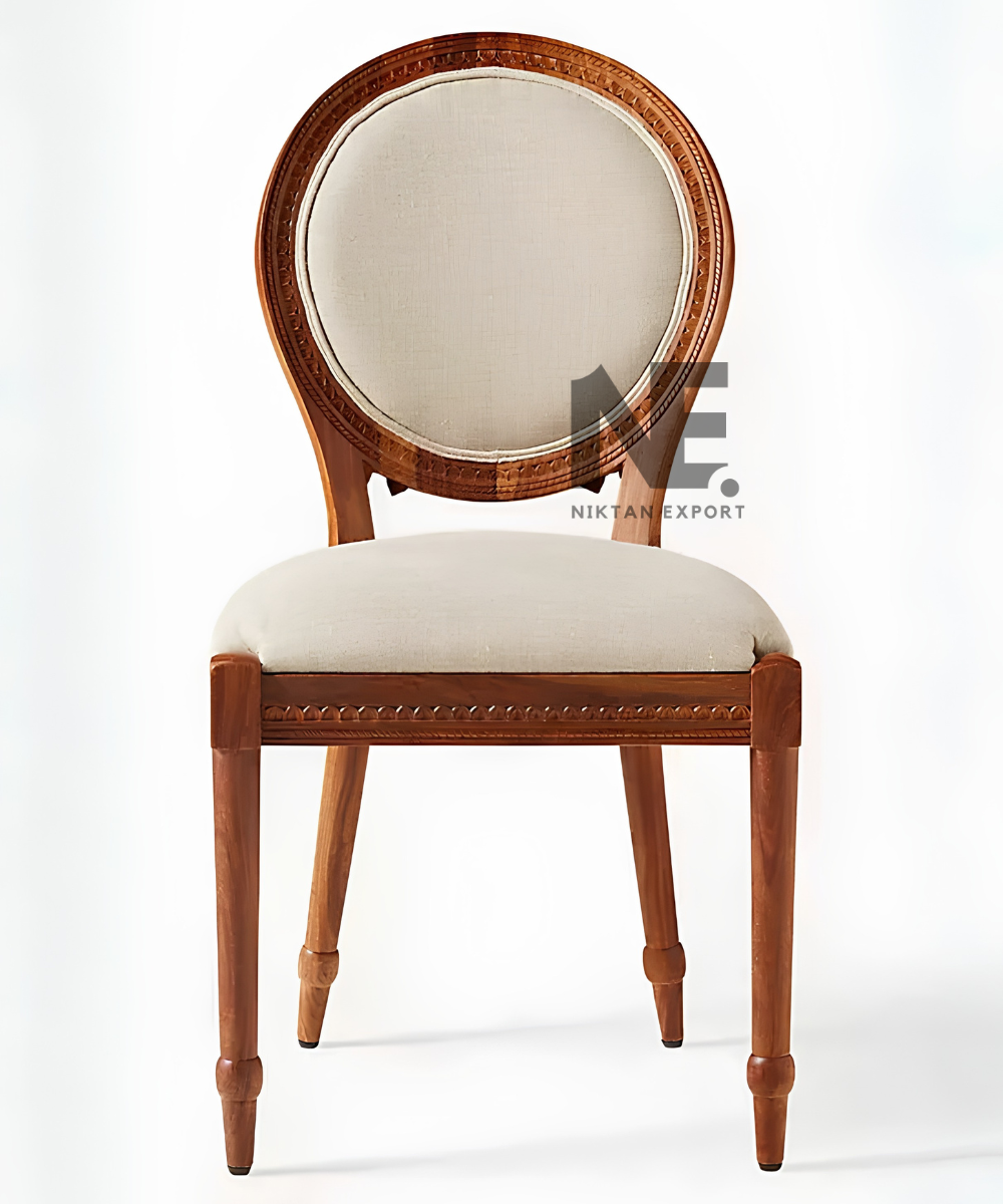 Front view of carved wooden chair with cream upholstered seat
