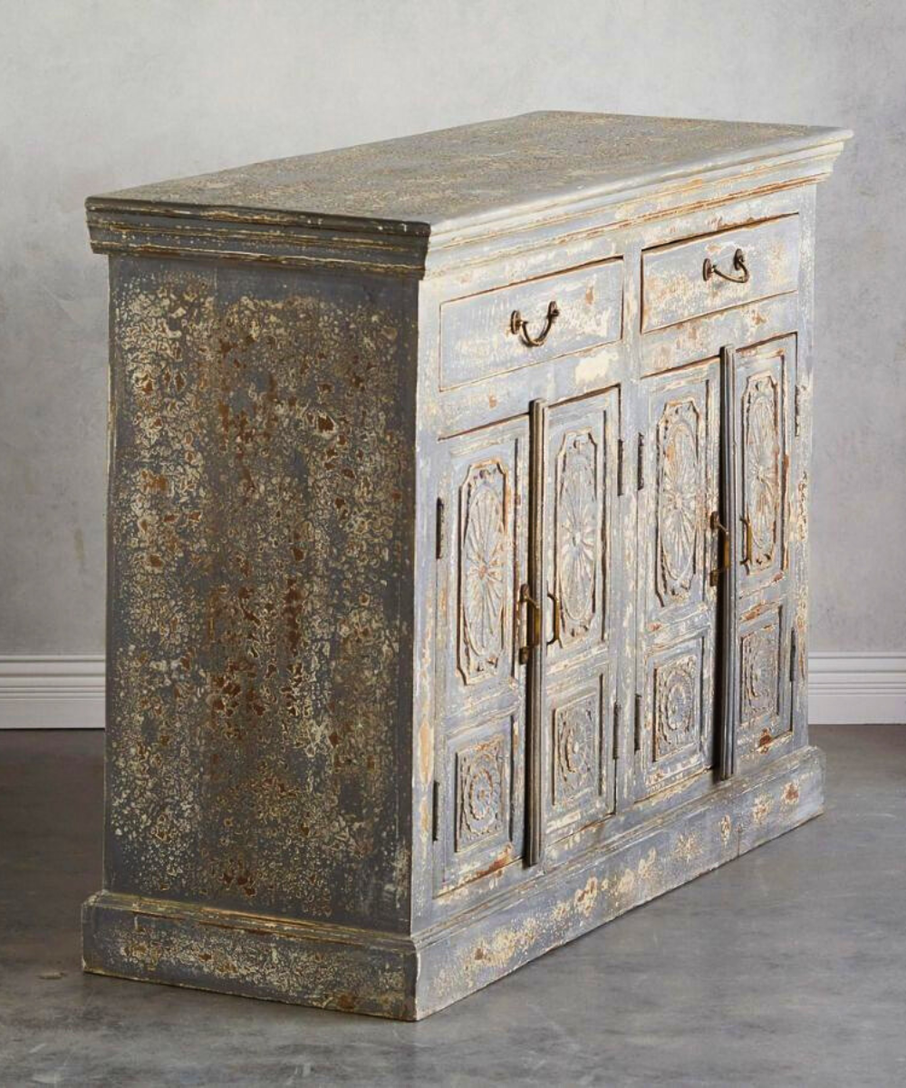 Close-up of hand-carved details on the mango wood console