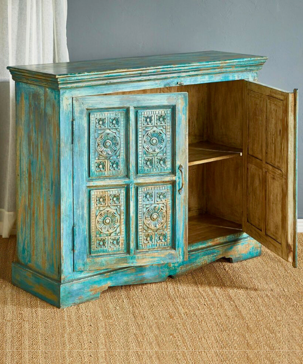 Antique-style teal blue sideboard in a rustic setting