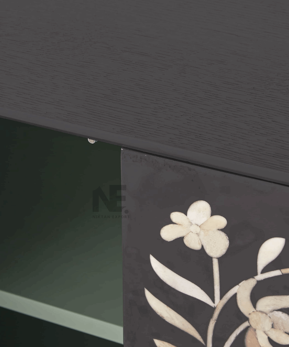 Close-up of intricate white inlay pattern on black background