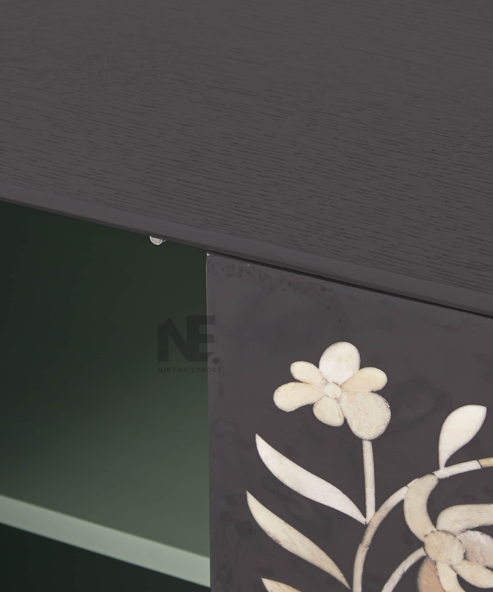 Close-up of intricate white inlay pattern on black background