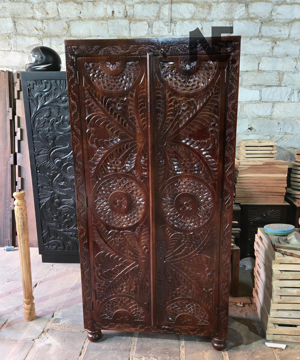 Ornate floral and geometric carving on wooden armoire doors