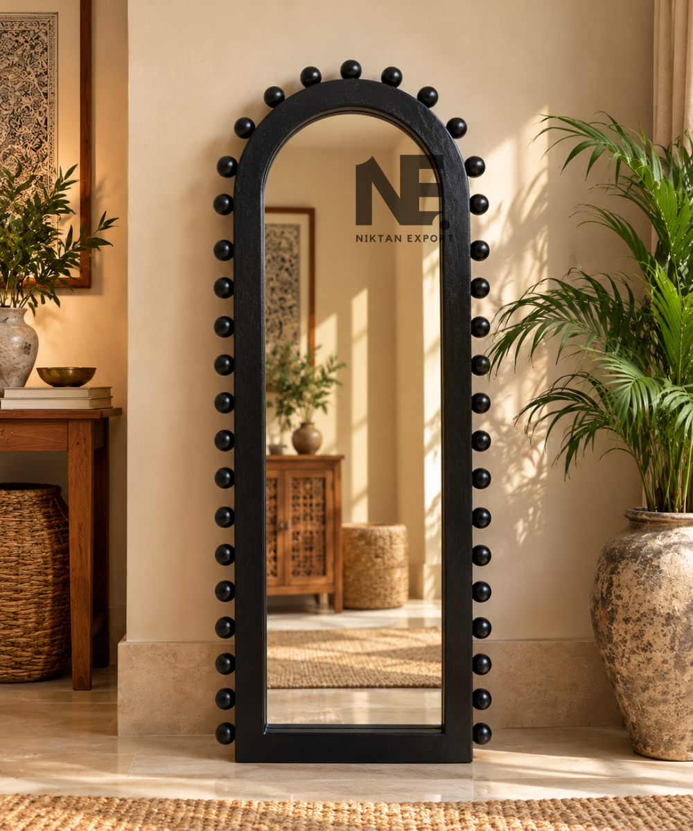 Arched black wooden mirror with decorative rounded studs