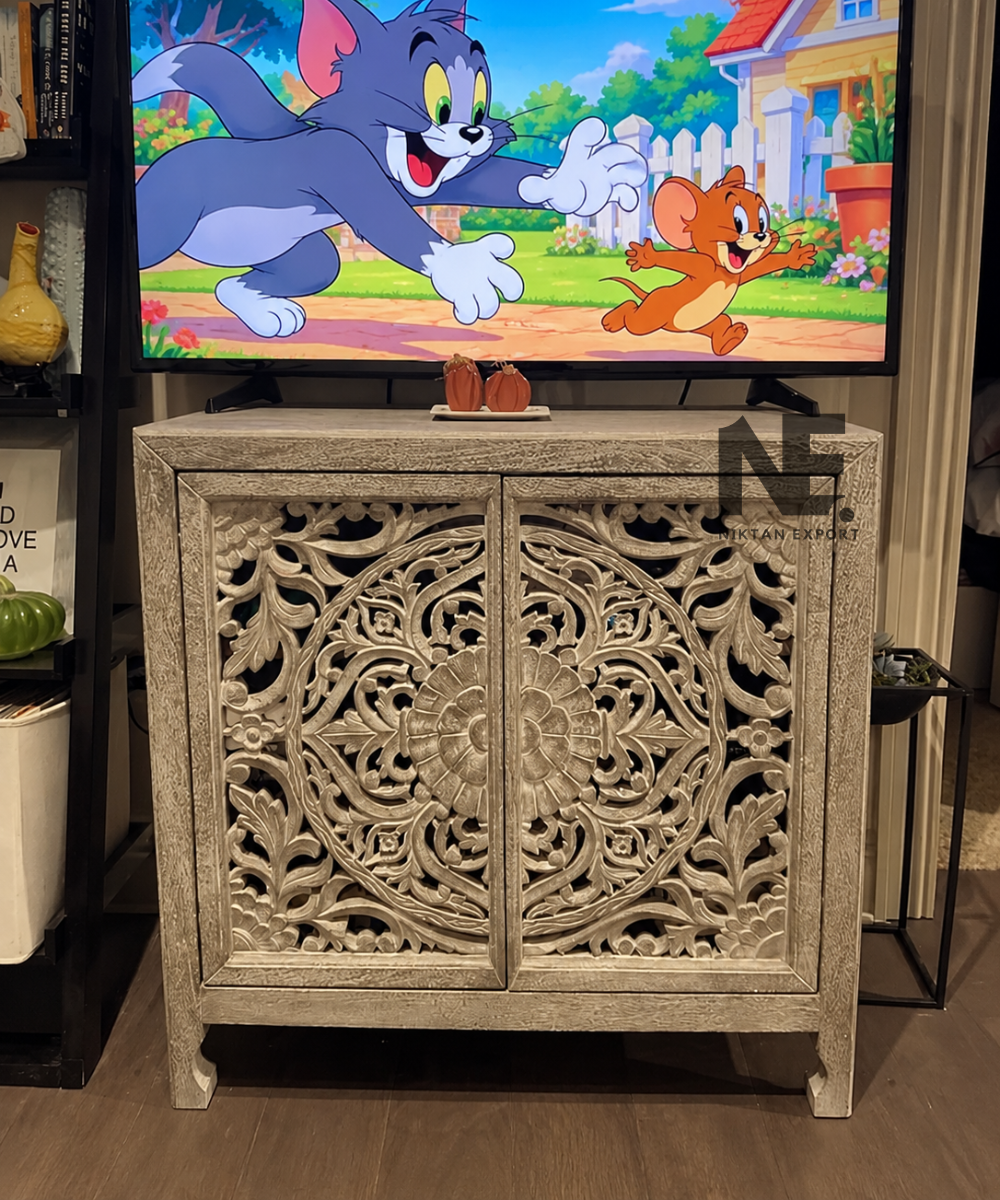 Carved wooden cabinet with floral cutout doors in whitewashed taupe