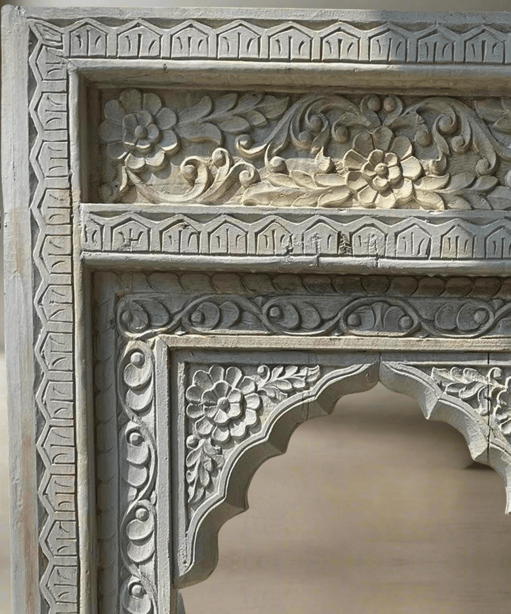 Close-up of intricate carved mango wood detailing