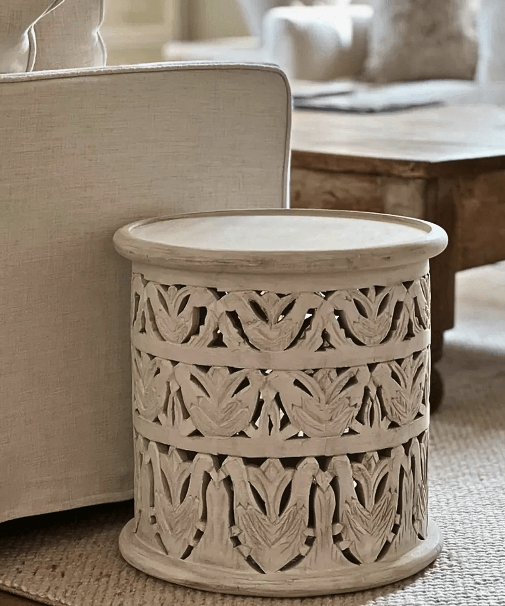 Intricate Hand-Carved Details on Whitewashed Table