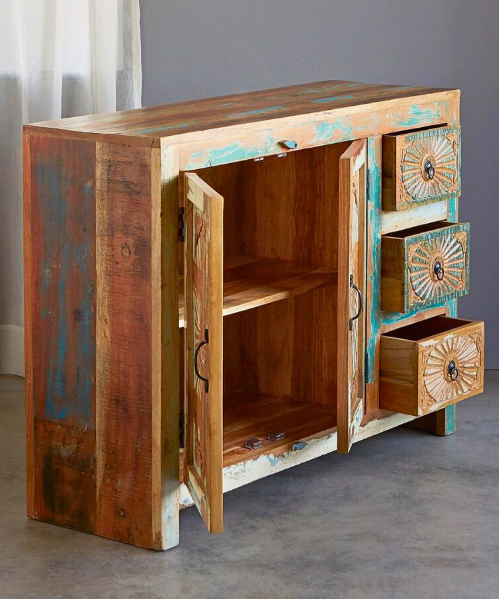 Close-up of hand-carved sunflower details on the cabinet