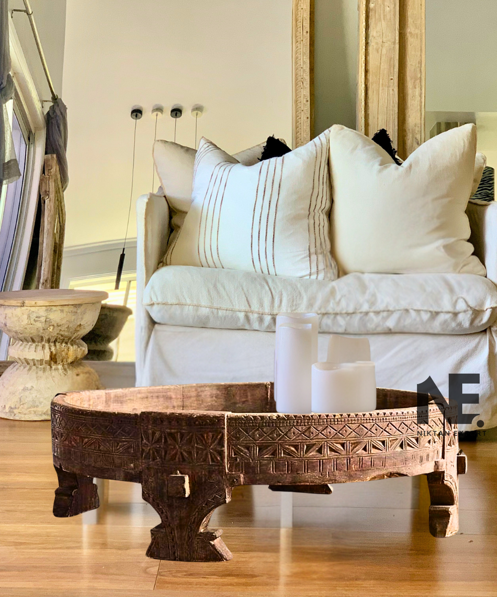 Intricate carvings on traditional chakki table – close-up