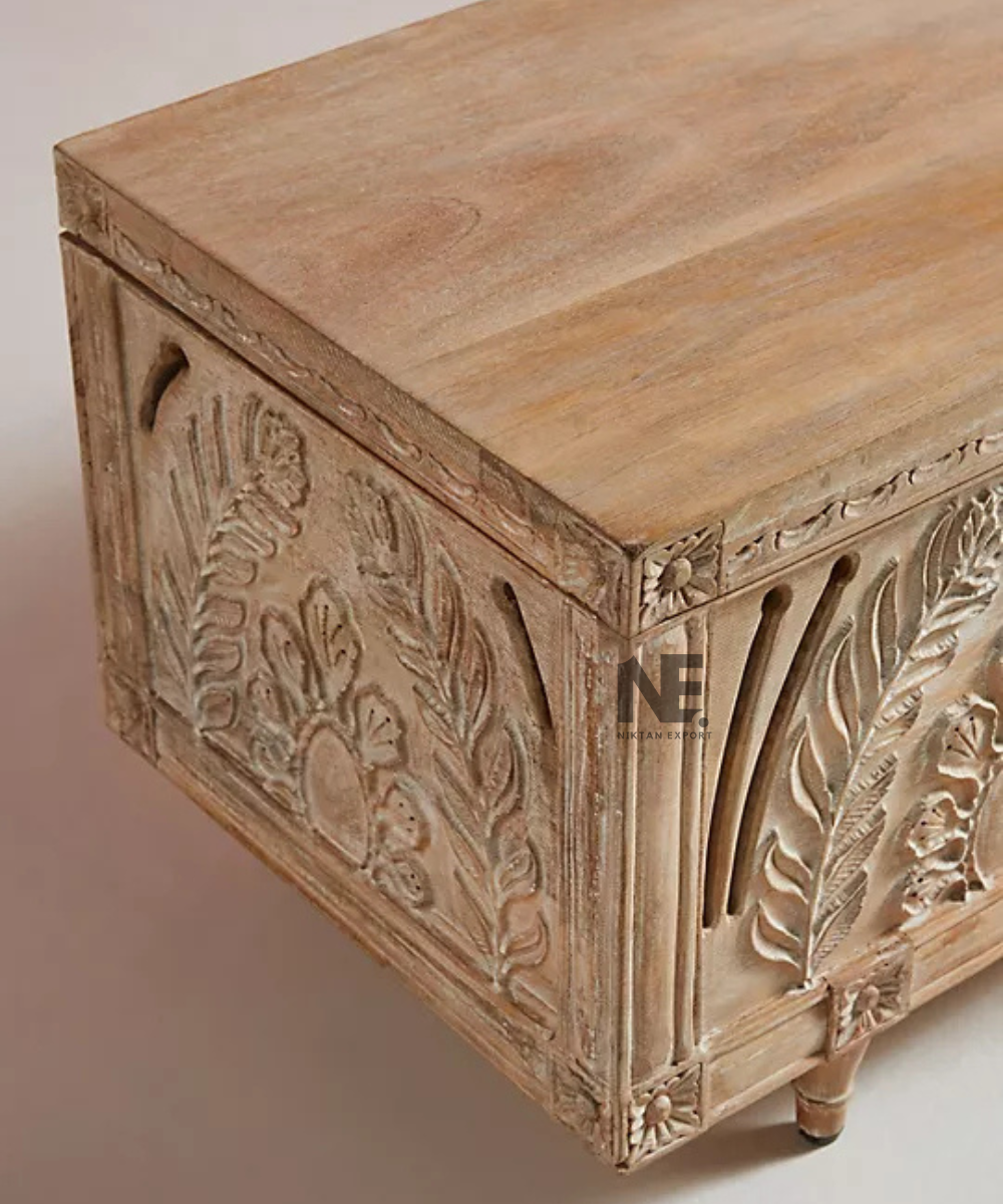 Close-up of floral carving on whitewashed wooden trunk