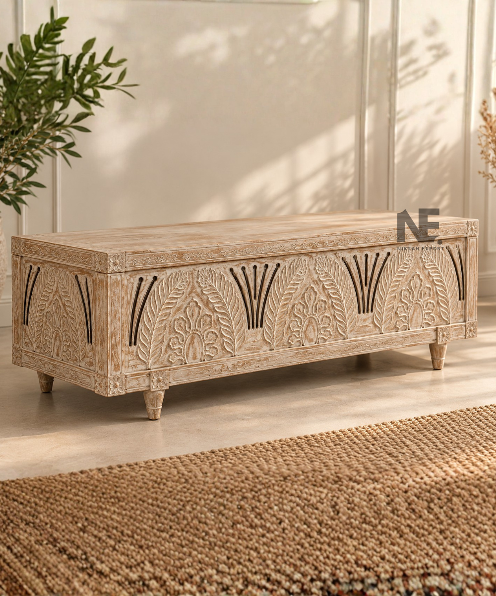Front view of carved wooden trunk with leafy decorative motifs