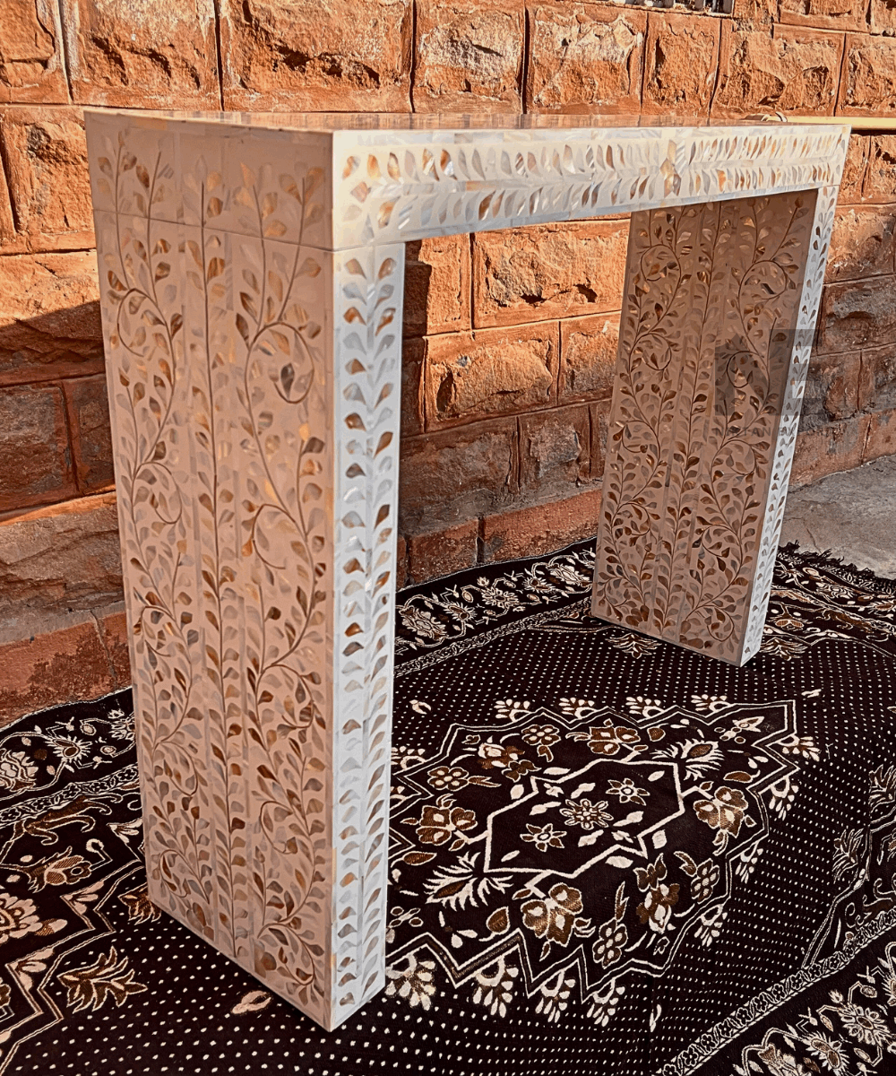 Set of console and bedside tables in a styled living space