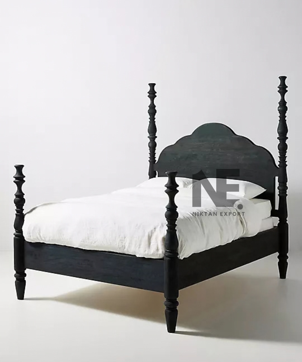 Scalloped headboard on a black wooden poster bed