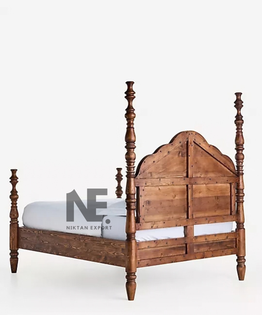 Dark wooden four poster bed with classic headboard design