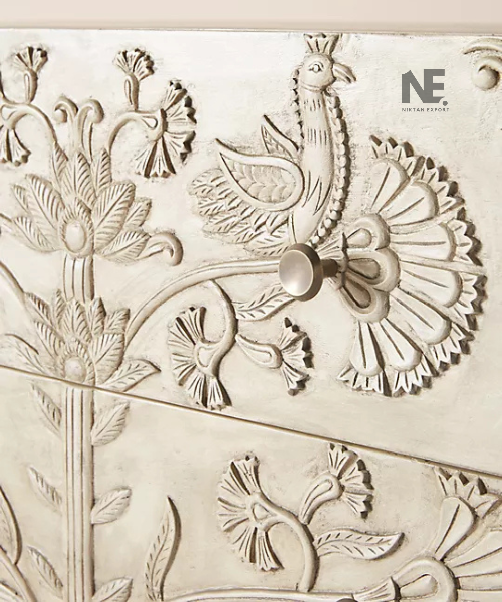 Close-up of floral carving on wooden drawer fronts