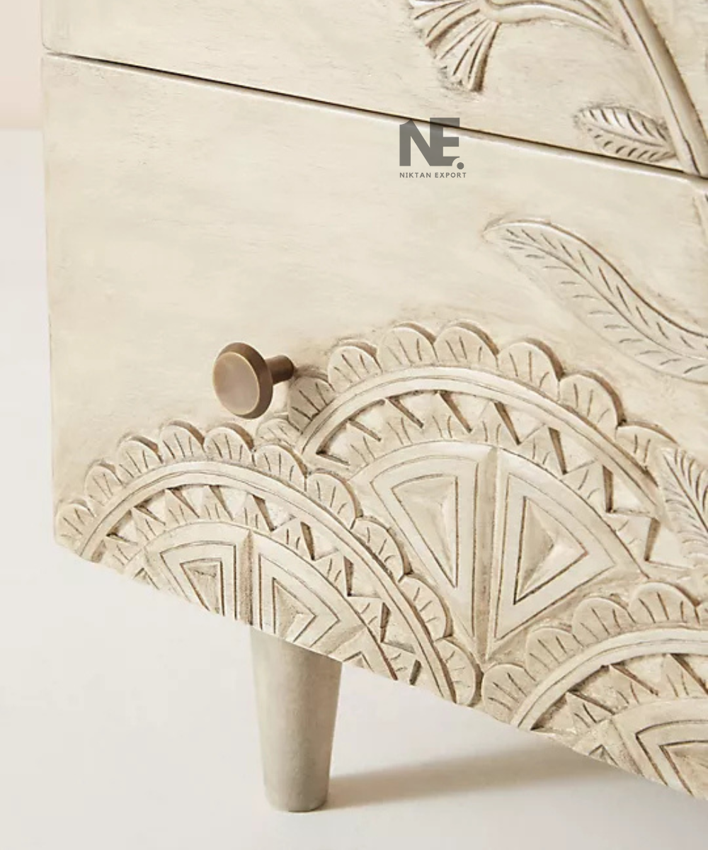 Detailed leaf motifs on carved wooden chest of drawers
