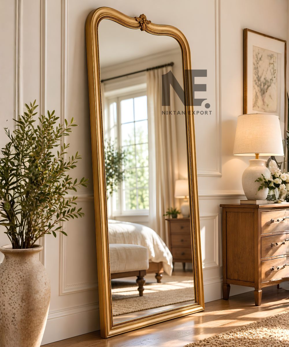 Front view of a tall antique gold decorative mirror