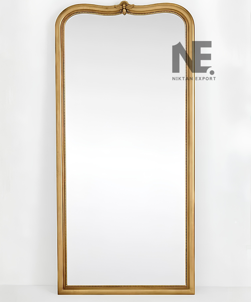 Decorative moulding on an arched gold mirror frame