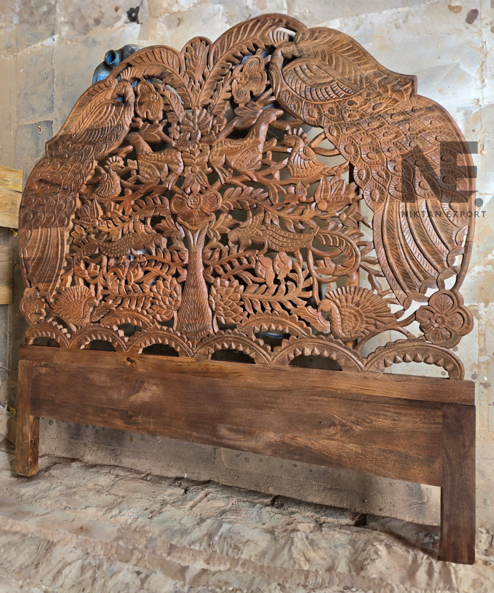 Detailed bird and floral motifs on a carved headboard