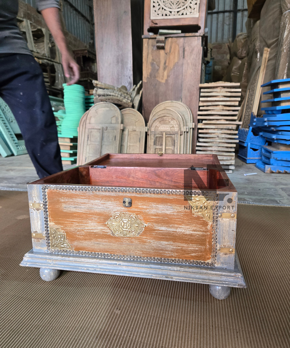 Wooden storage chest with central metal-tone latch