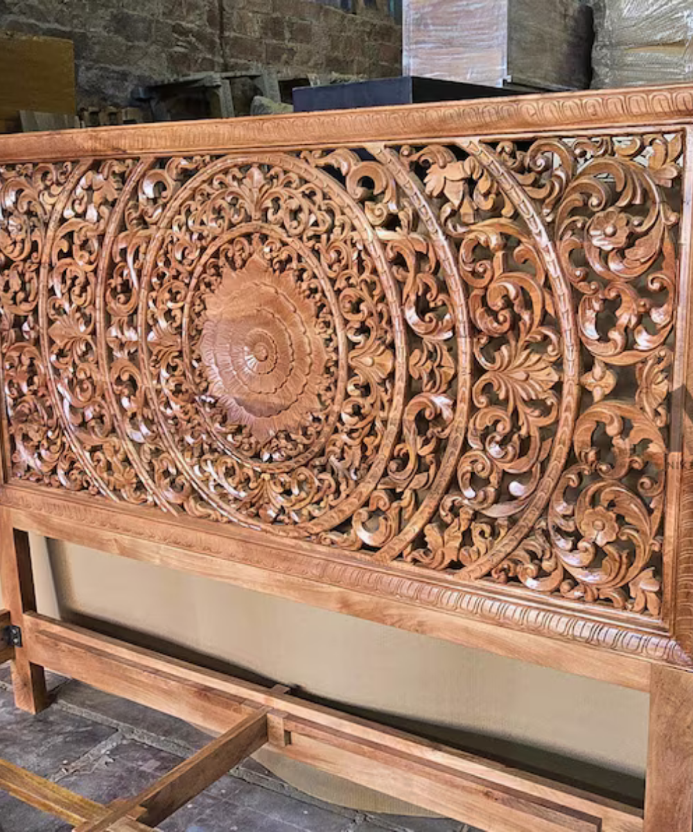 Hand carved floral headboard on wooden king bed