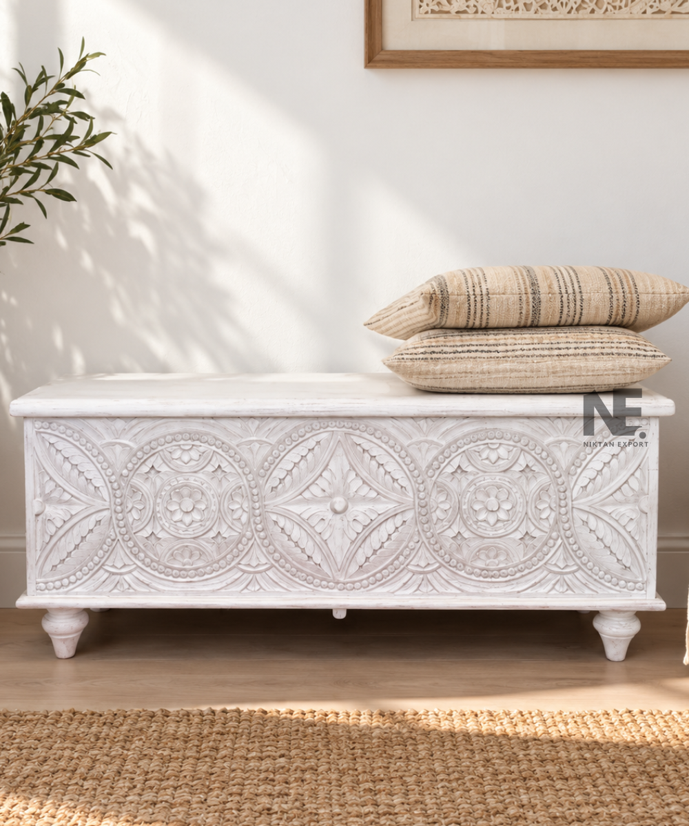 Whitewashed carved wooden storage chest with ornate floral front