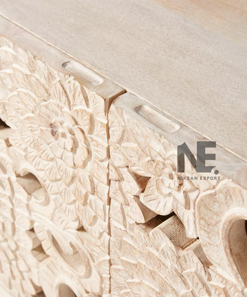 Ivory floral cabinet styled against a neutral interior wall