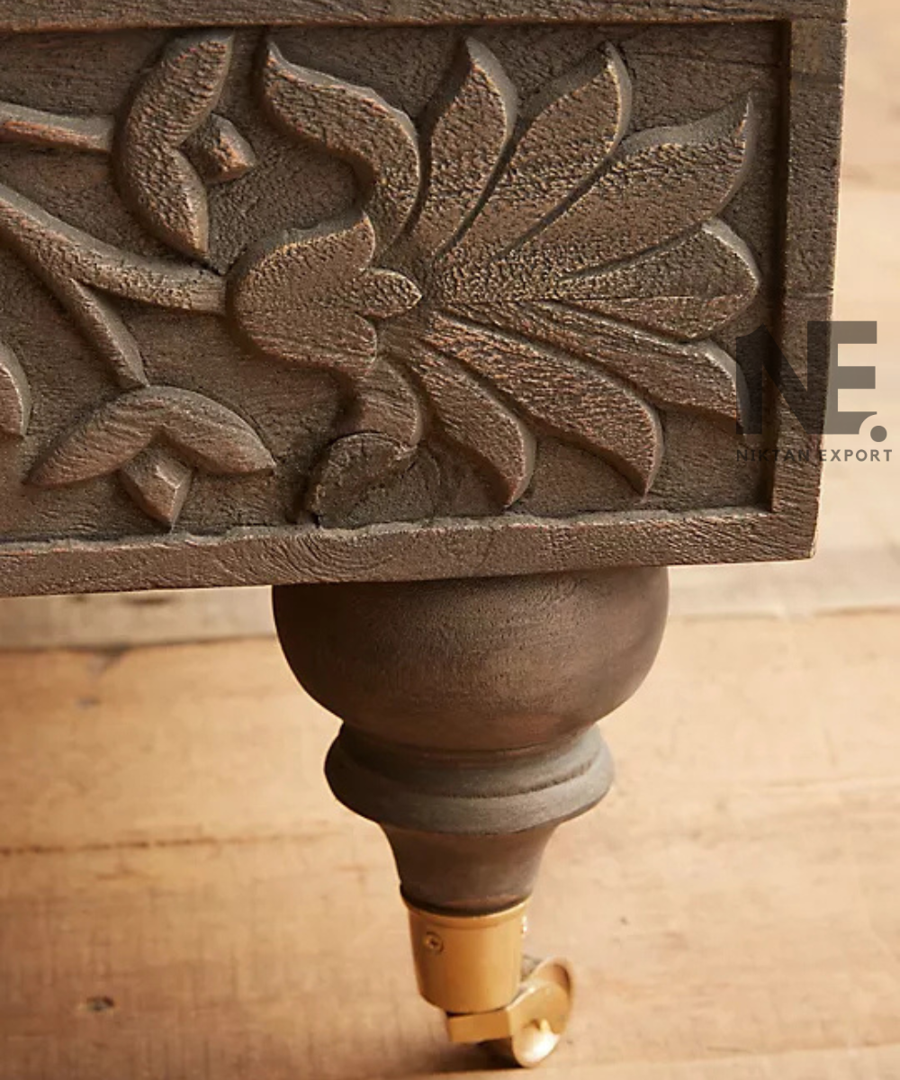 Nature-inspired carving detail on a wooden bed