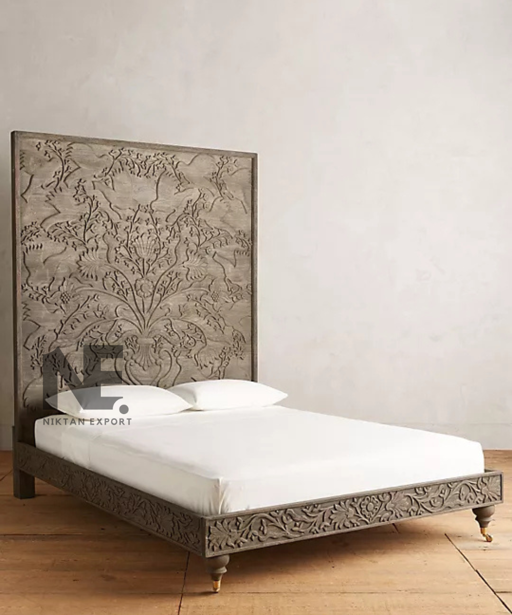 Wooden bed with intricate bird and floral headboard