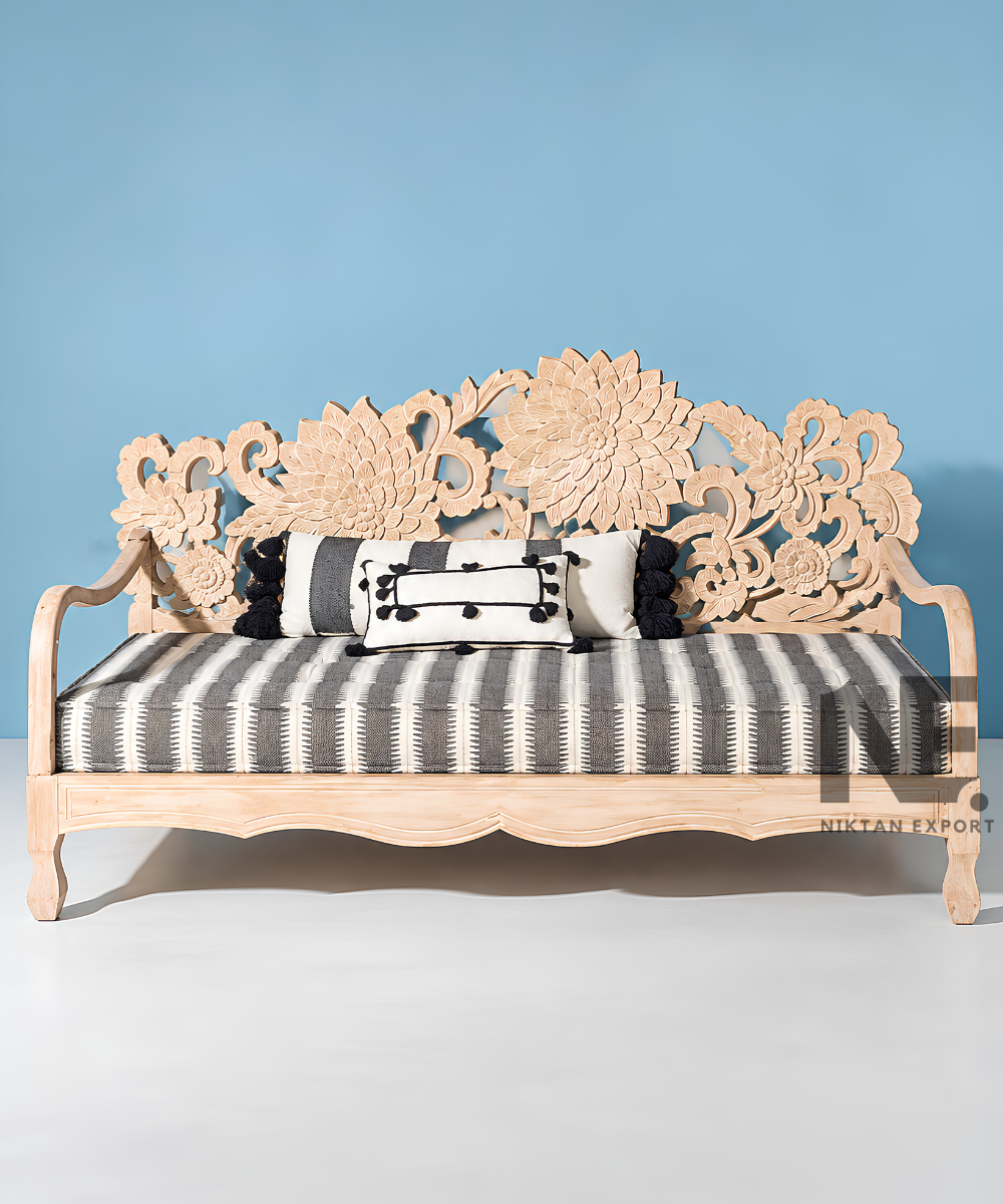 Front view of a wooden daybed with floral carving