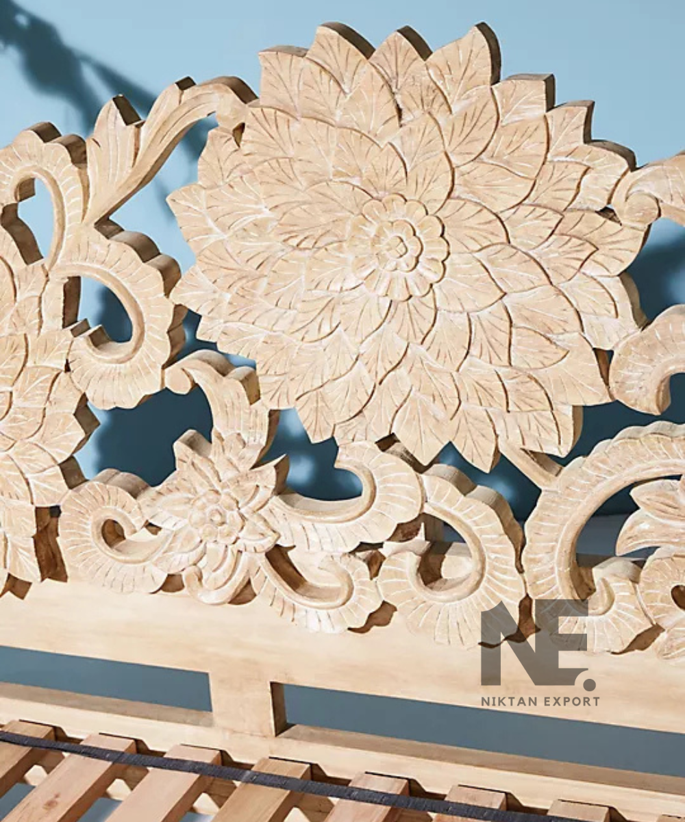 Wooden daybed with curved arms and carved frame