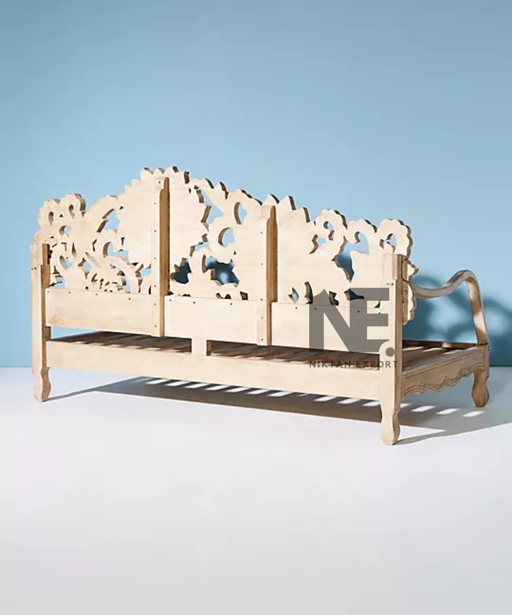 Intricate floral woodwork on a traditional daybed