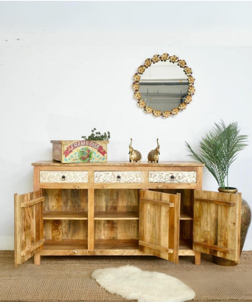 Angled view of hand-carved mango wood sideboard with natural white finish
