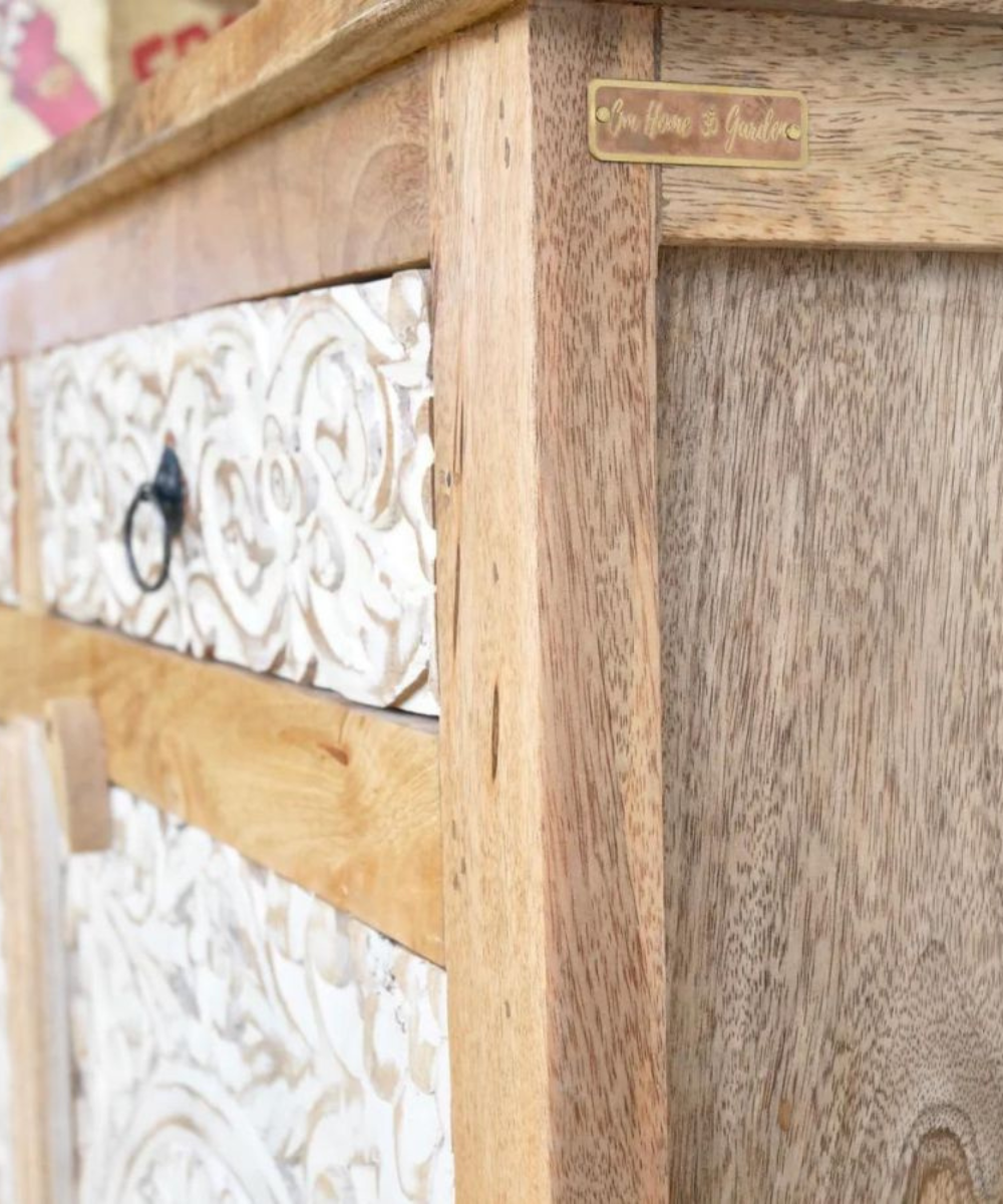 Elegant white cabinet with floral design in a rustic living room setting