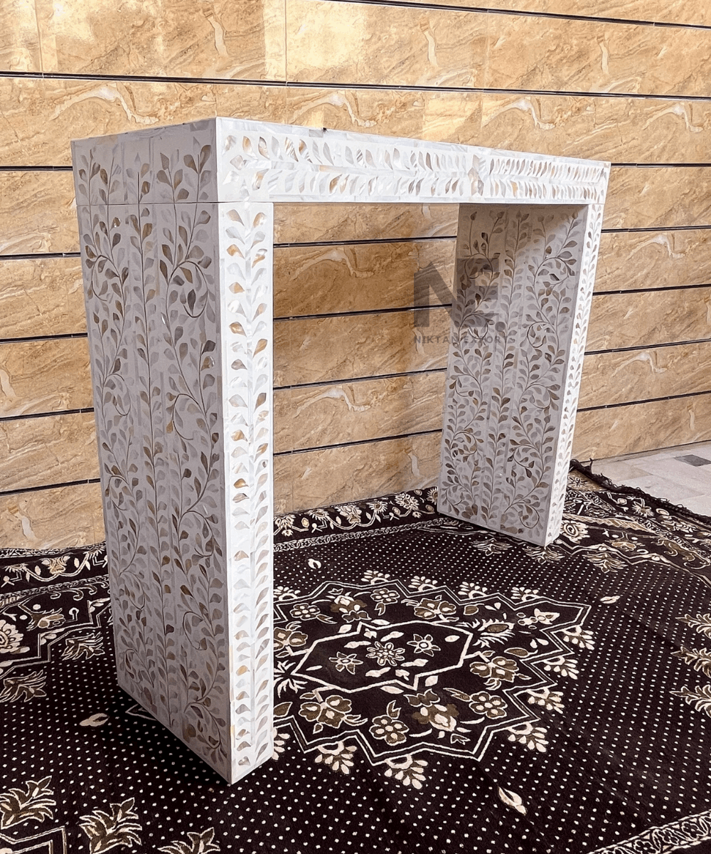 Scalloped edges on white inlay console table