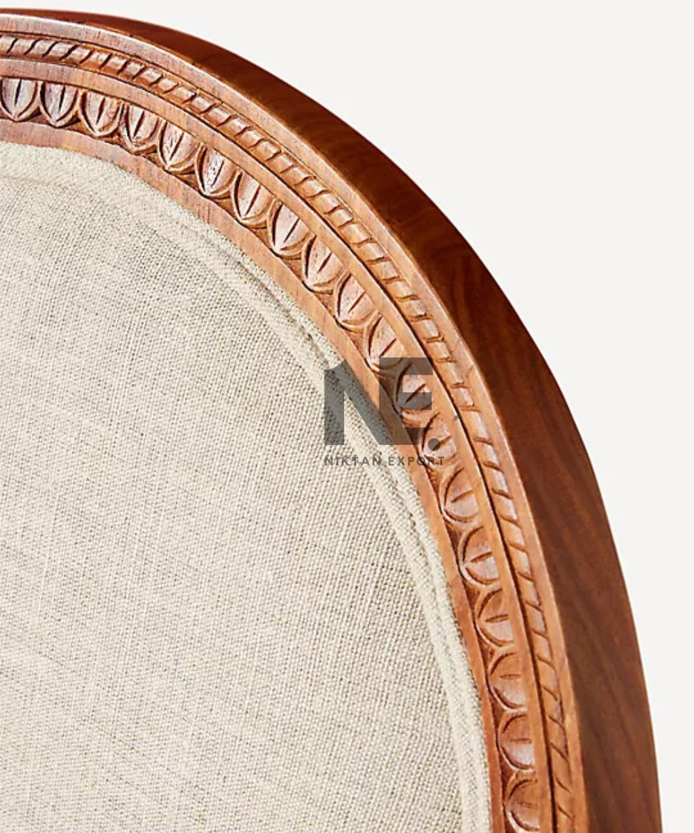 Rounded backrest with intricate tree carving on wooden chair