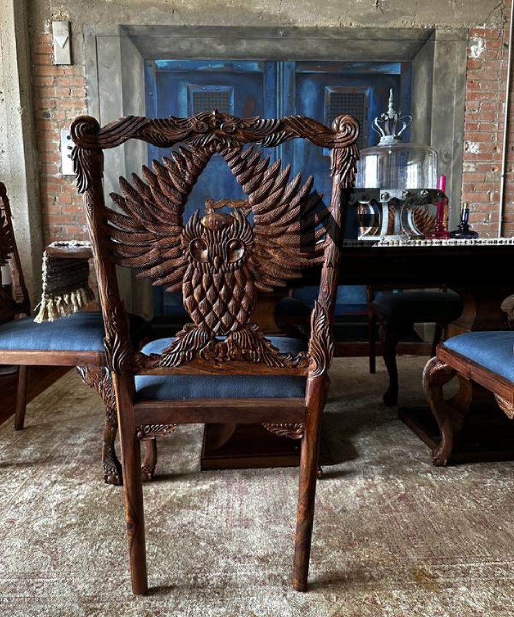 Brown carved dining chair with dark upholstered seat