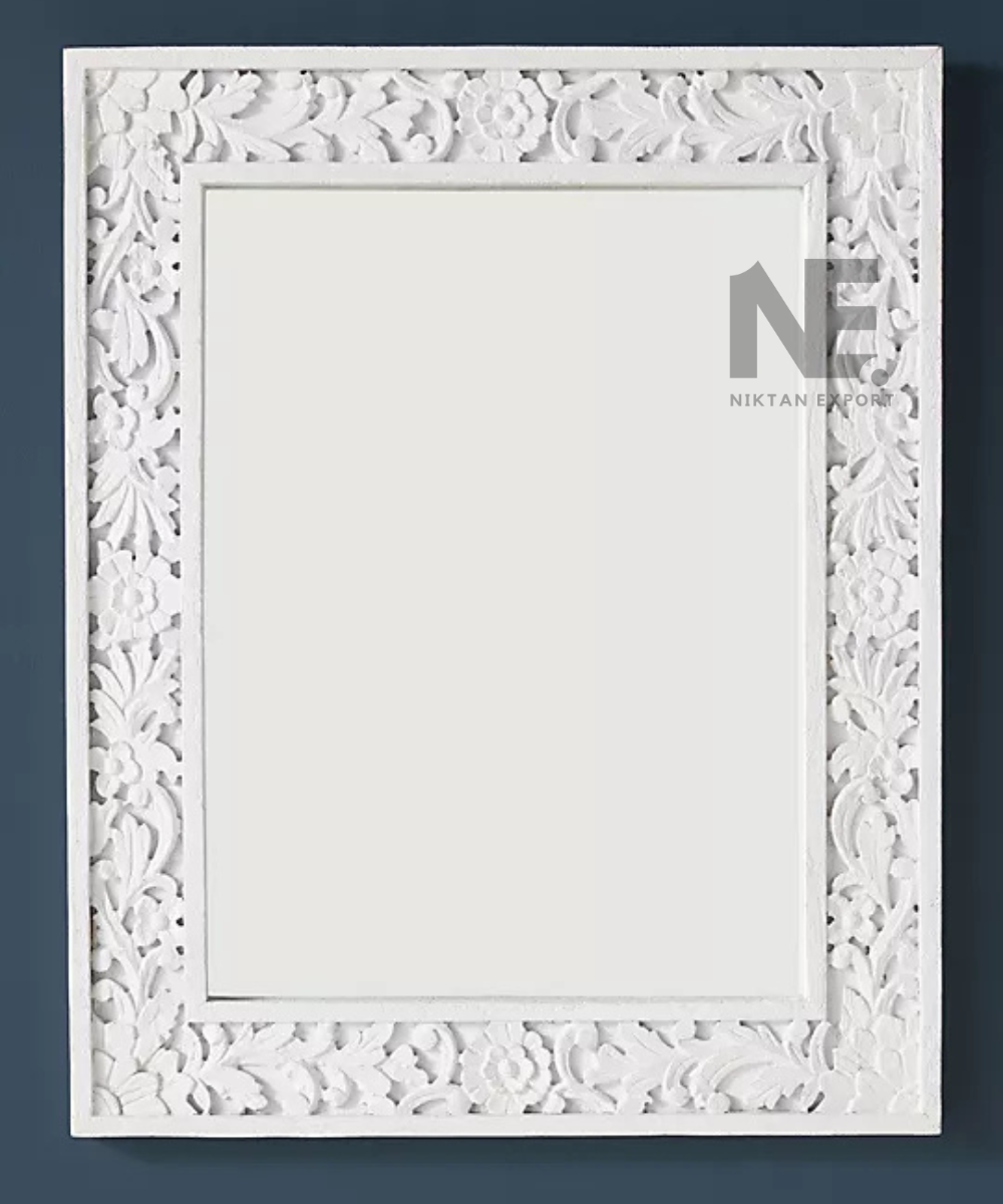 White floral carved mirror with ornate rectangular frame