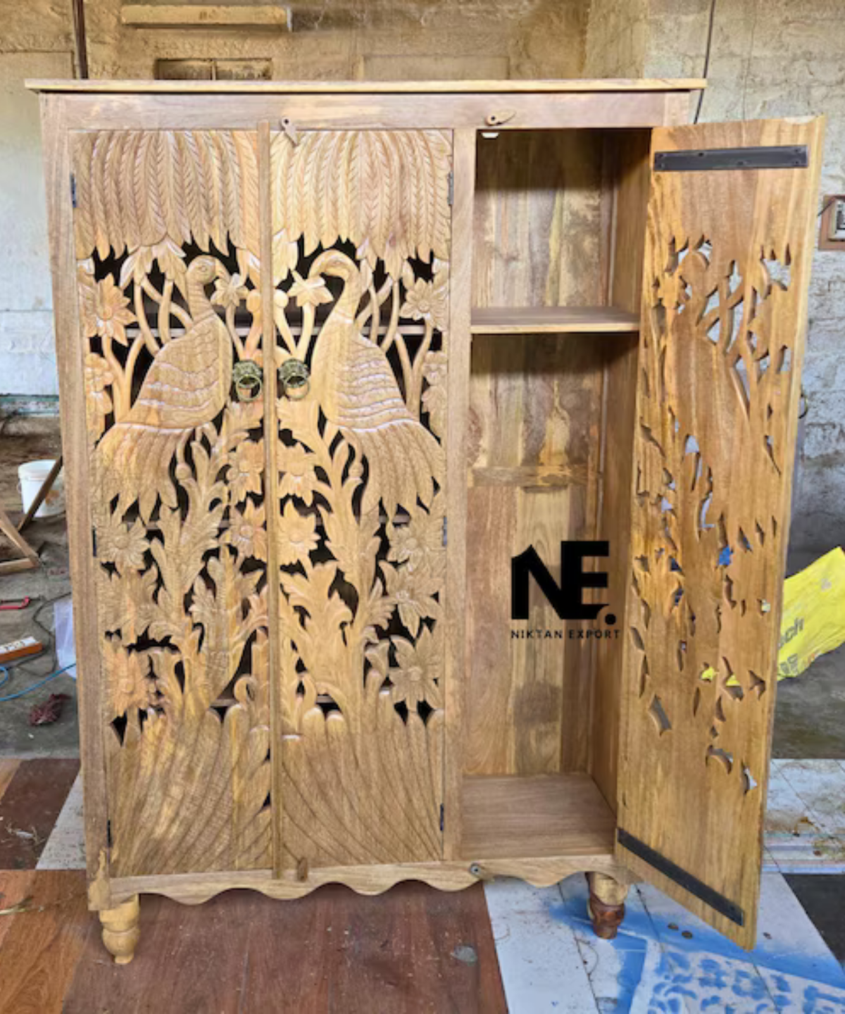 detailed peacock carving on wooden wardrobe