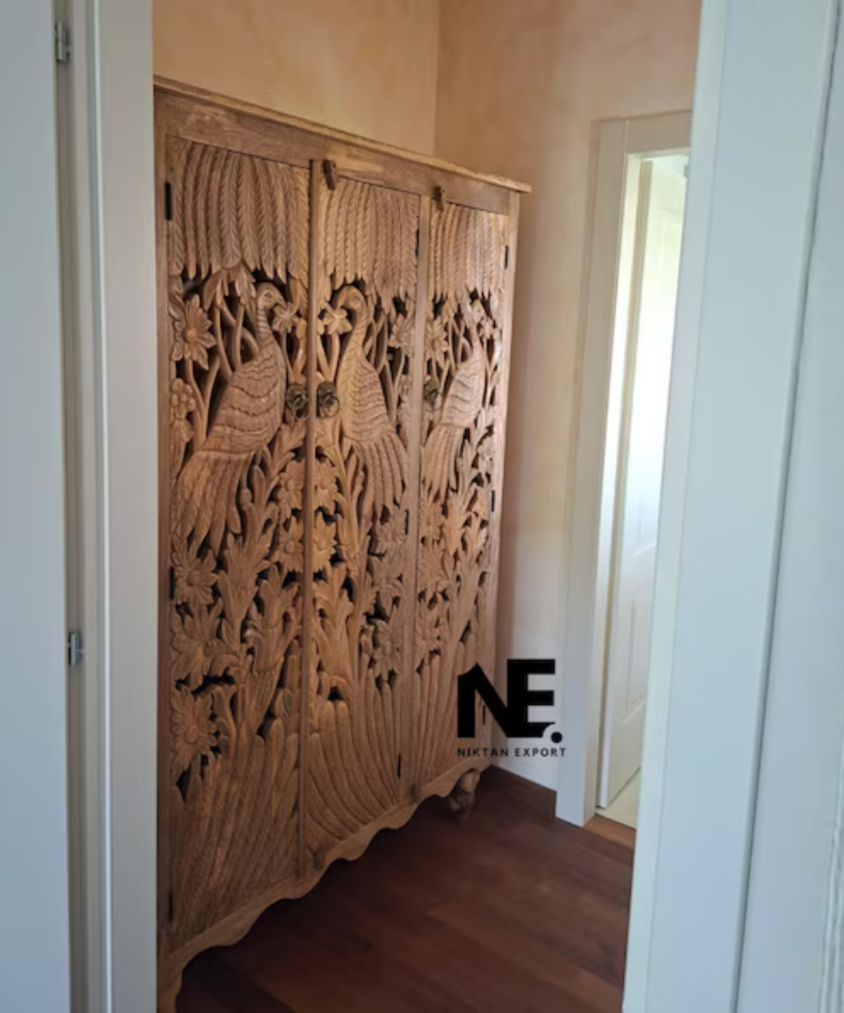 hand carved peacock armoire with floral detailing
