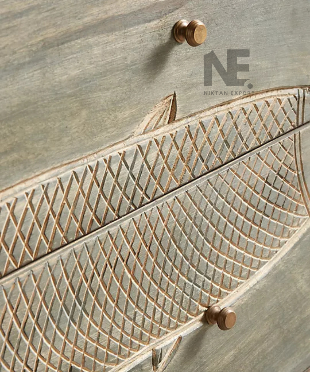Close-up of decorative fish motif on sideboard drawer