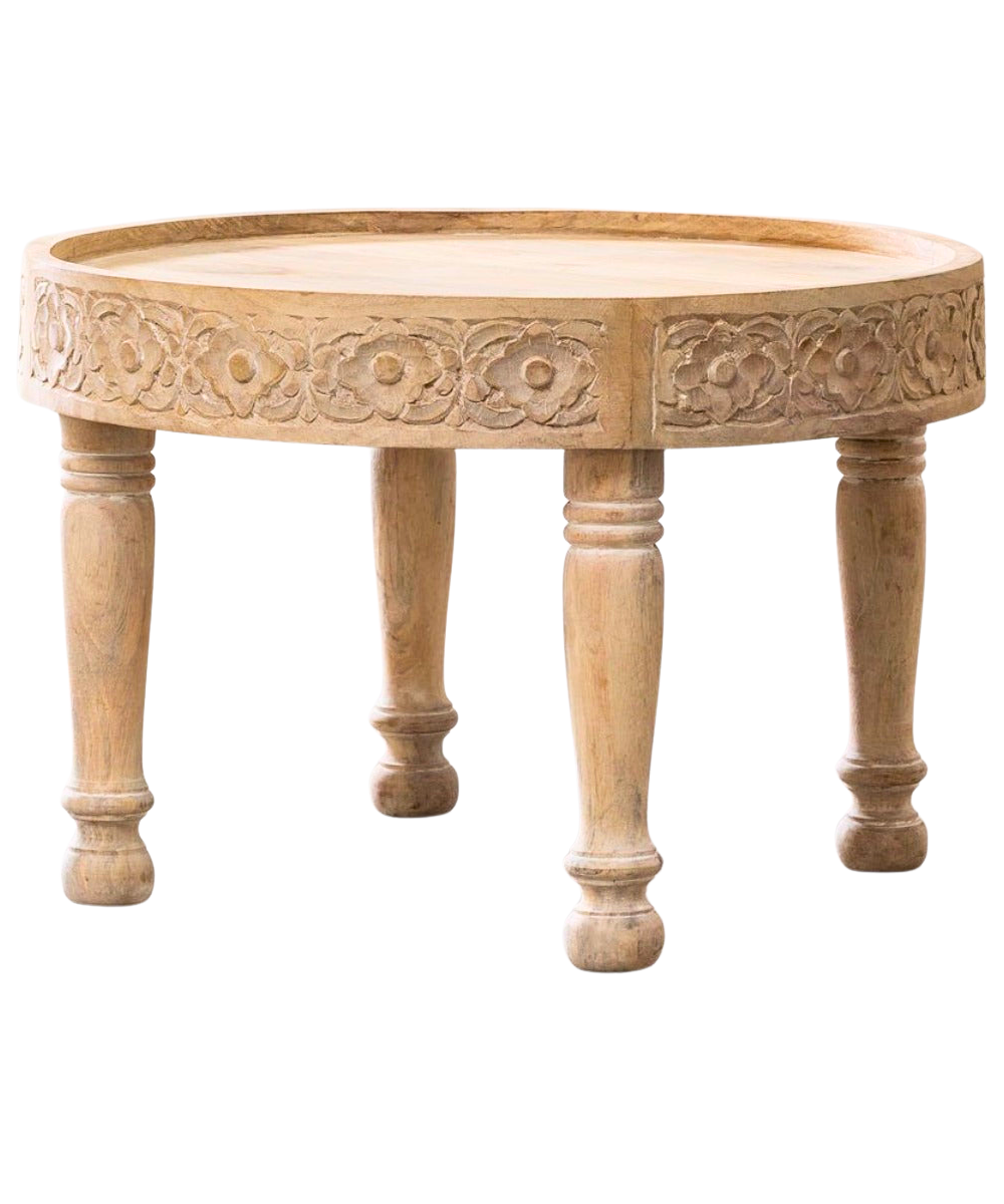 Close-up of intricate wood carvings on coffee table