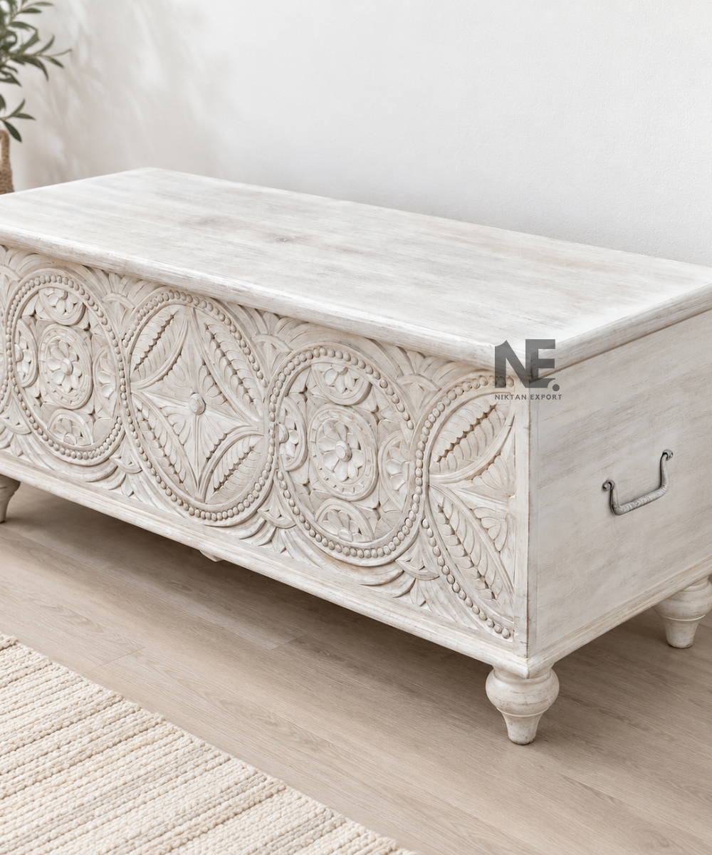 Front view of whitewashed wooden chest with geometric floral carving